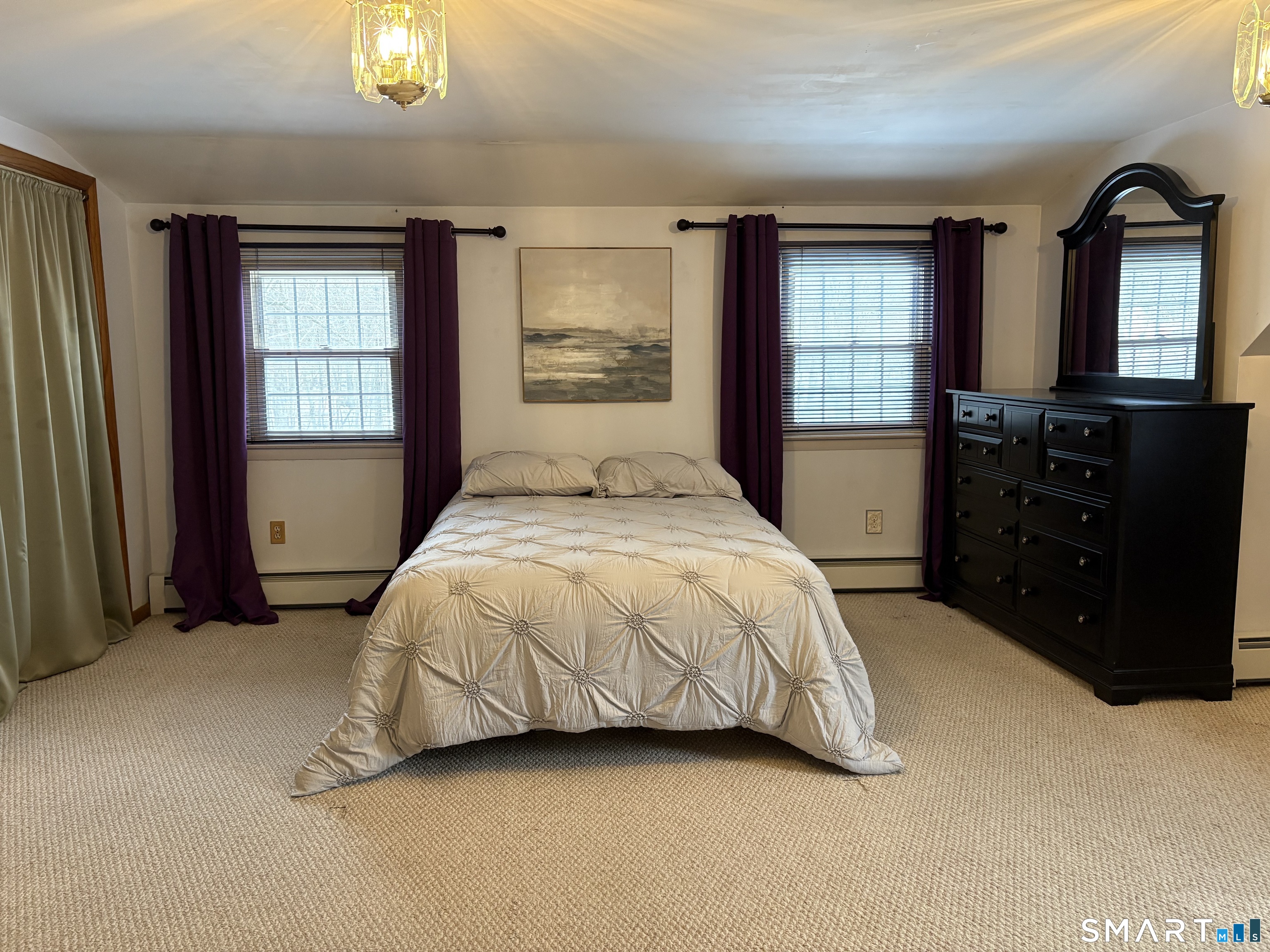 100 North Airline Road Wallingford, CT 06492 - Photo 19 of 40 The enormous primary bedroom has plenty of room for king-sized furniture plus room for a cozy seating space.