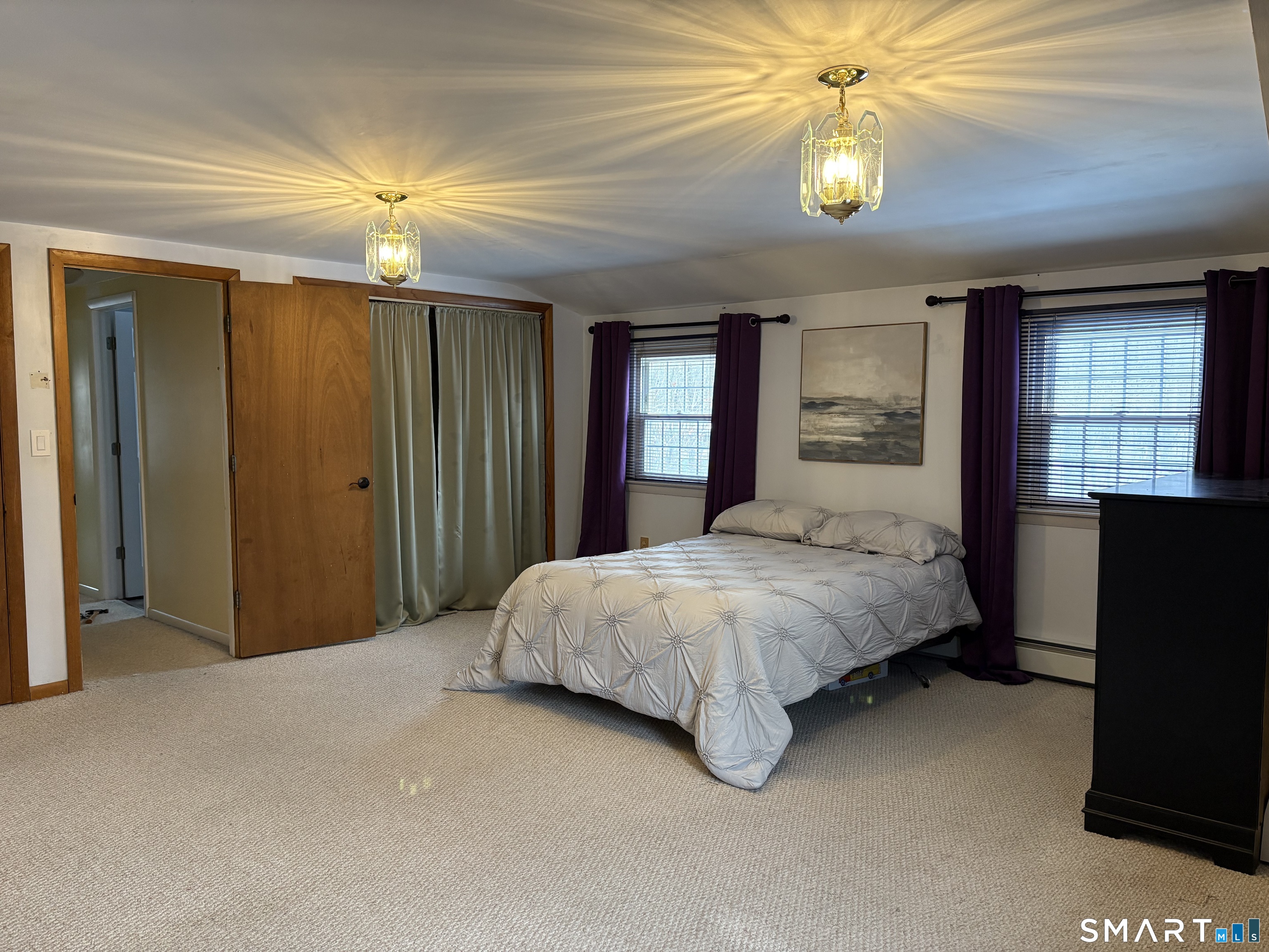 100 North Airline Road Wallingford, CT 06492 - Photo 21 of 40 The primary bedroom features his and her closets. Pictured is the largest of the two closets, which offers ample room for your clothing and shoe storage.
