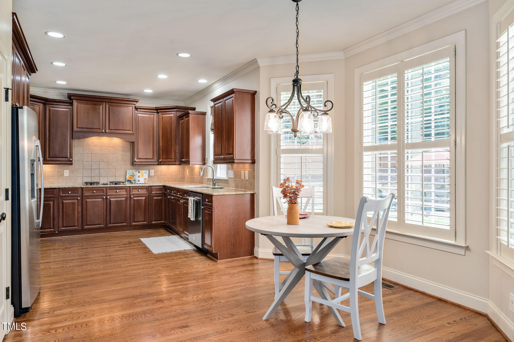 11519 Azari Court Raleigh, NC 27614 - Photo 14 of 55 a kitchen with a table chairs refrigerator and cabinets