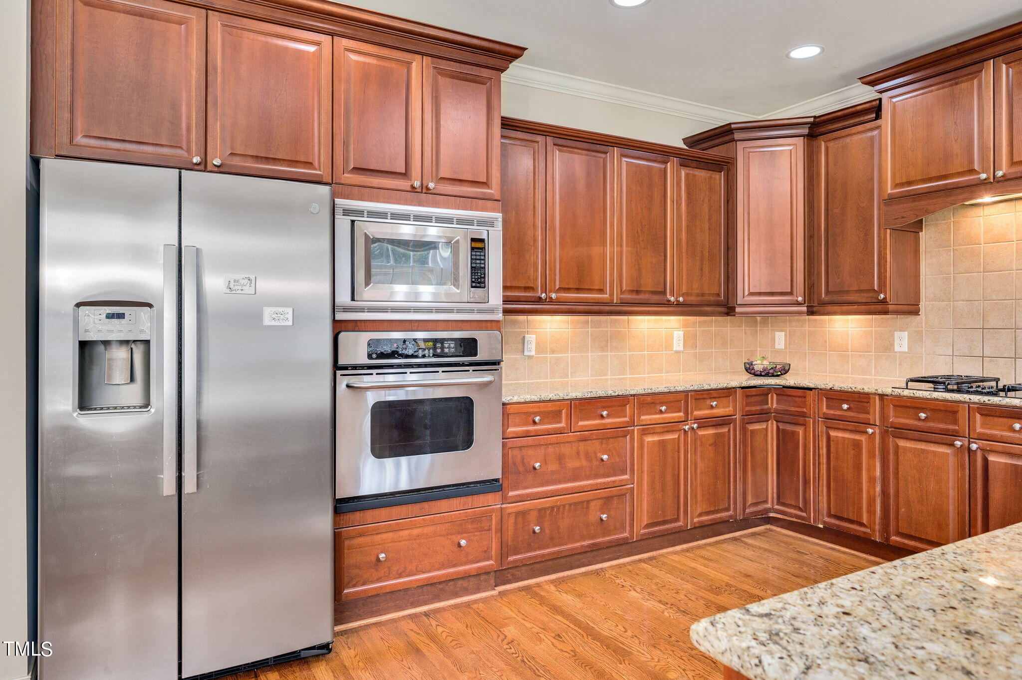 11519 Azari Court Raleigh, NC 27614 - Photo 16 of 55 a kitchen with granite countertop stainless steel appliances wooden cabinets a sink and a refrigerator