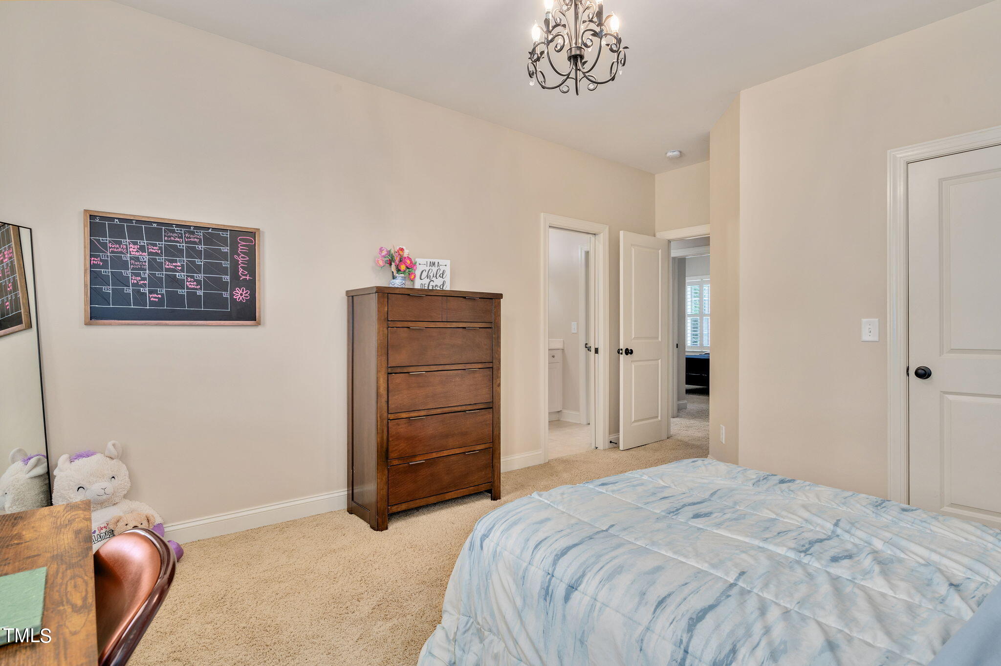 11519 Azari Court Raleigh, NC 27614 - Photo 29 of 55 a spacious bedroom with a bed and a chair