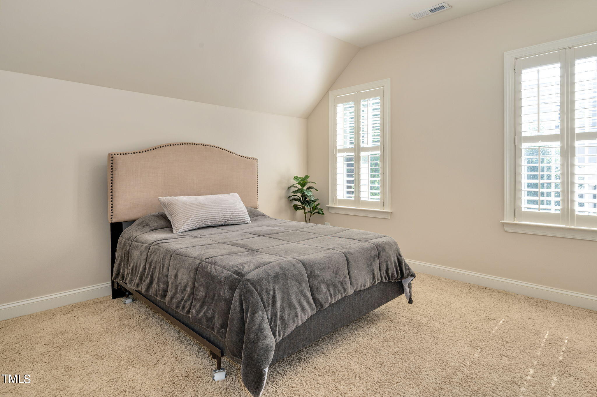 11519 Azari Court Raleigh, NC 27614 - Photo 32 of 55 a bed sitting in a bedroom next to a window