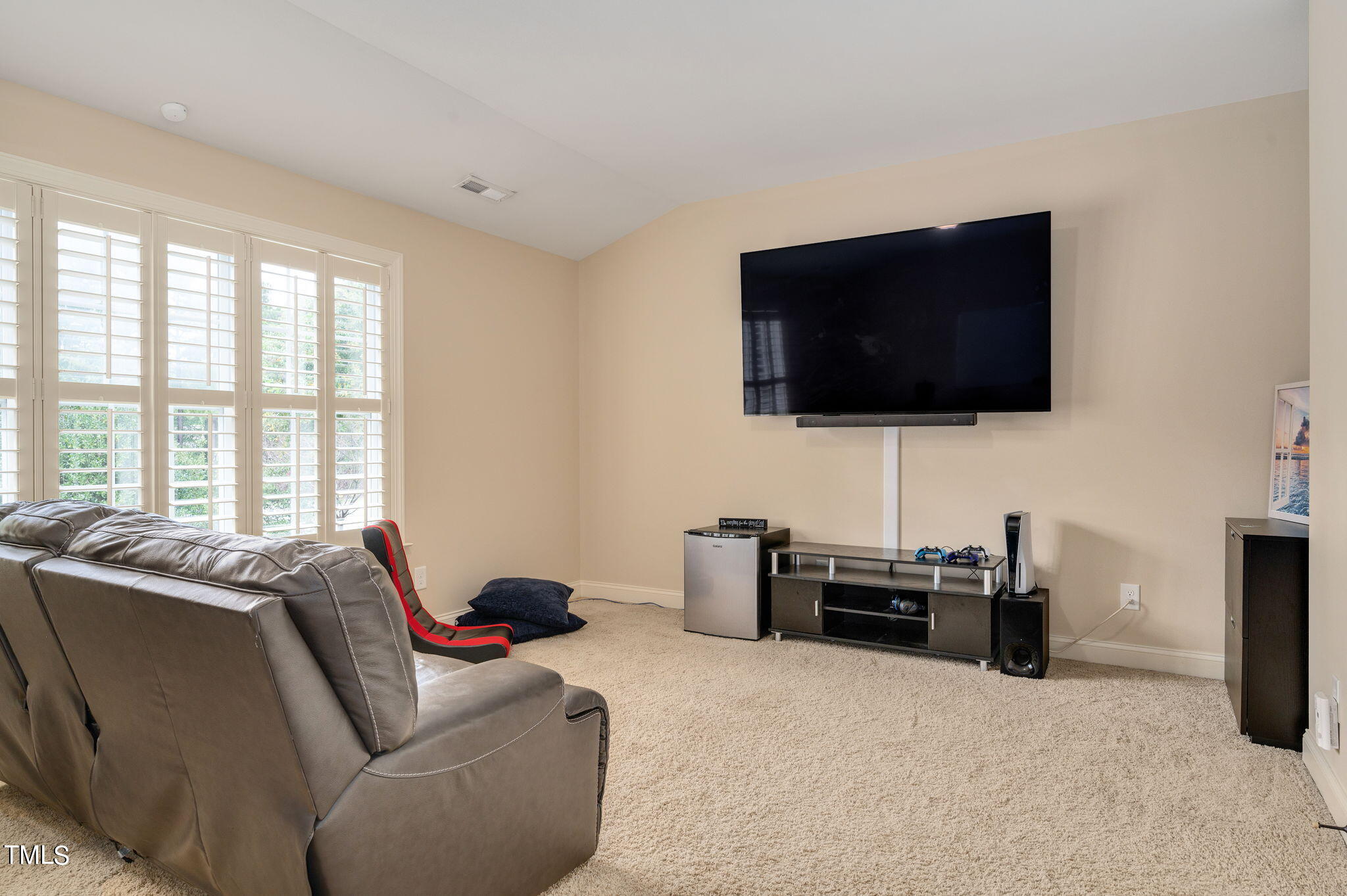 11519 Azari Court Raleigh, NC 27614 - Photo 40 of 55 a living room with furniture and a flat screen tv