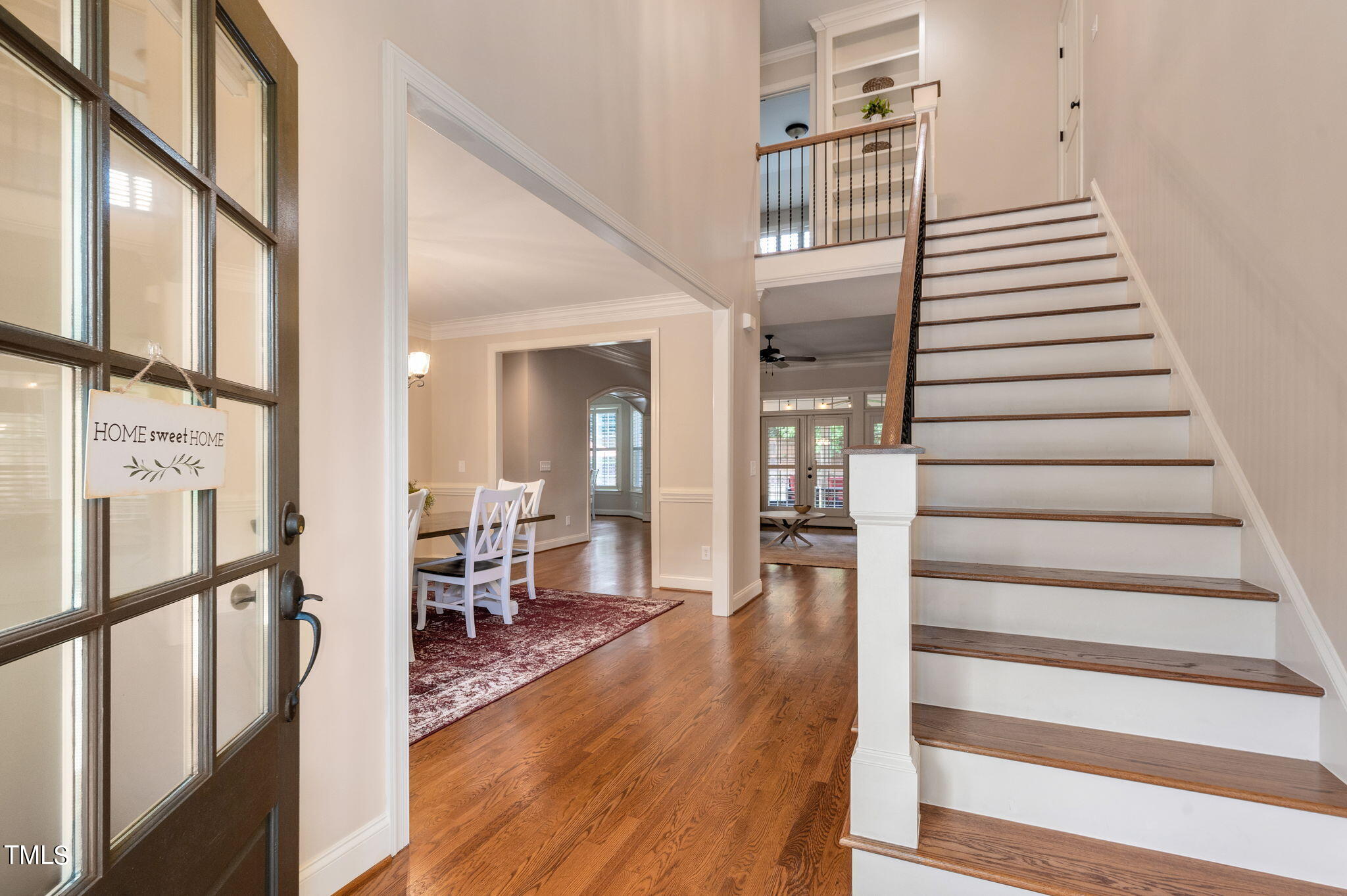 11519 Azari Court Raleigh, NC 27614 - Photo 7 of 55 a view of a hallway with wooden floor and staircase