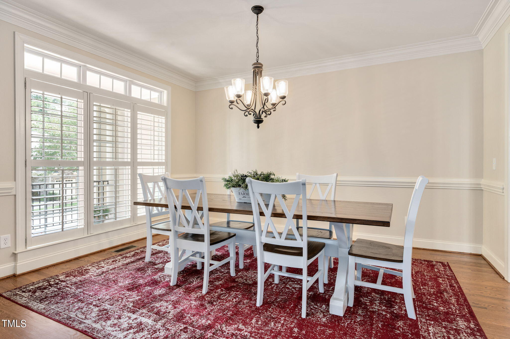 11519 Azari Court Raleigh, NC 27614 - Photo 8 of 55 a dining room with furniture a rug and a chandelier