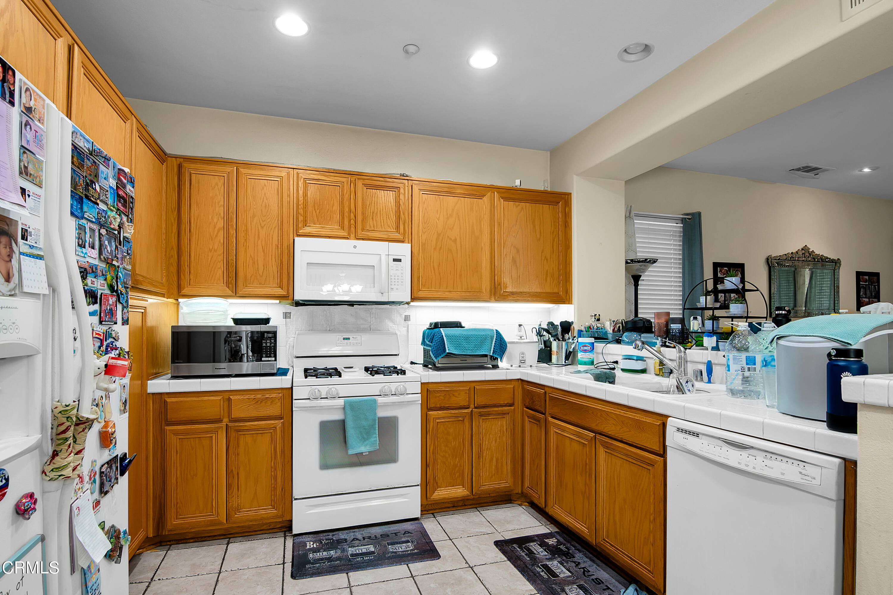 1611 Sonata Drive Oxnard, CA 93030 - Photo 11 of 25 a kitchen with a sink stove and cabinets