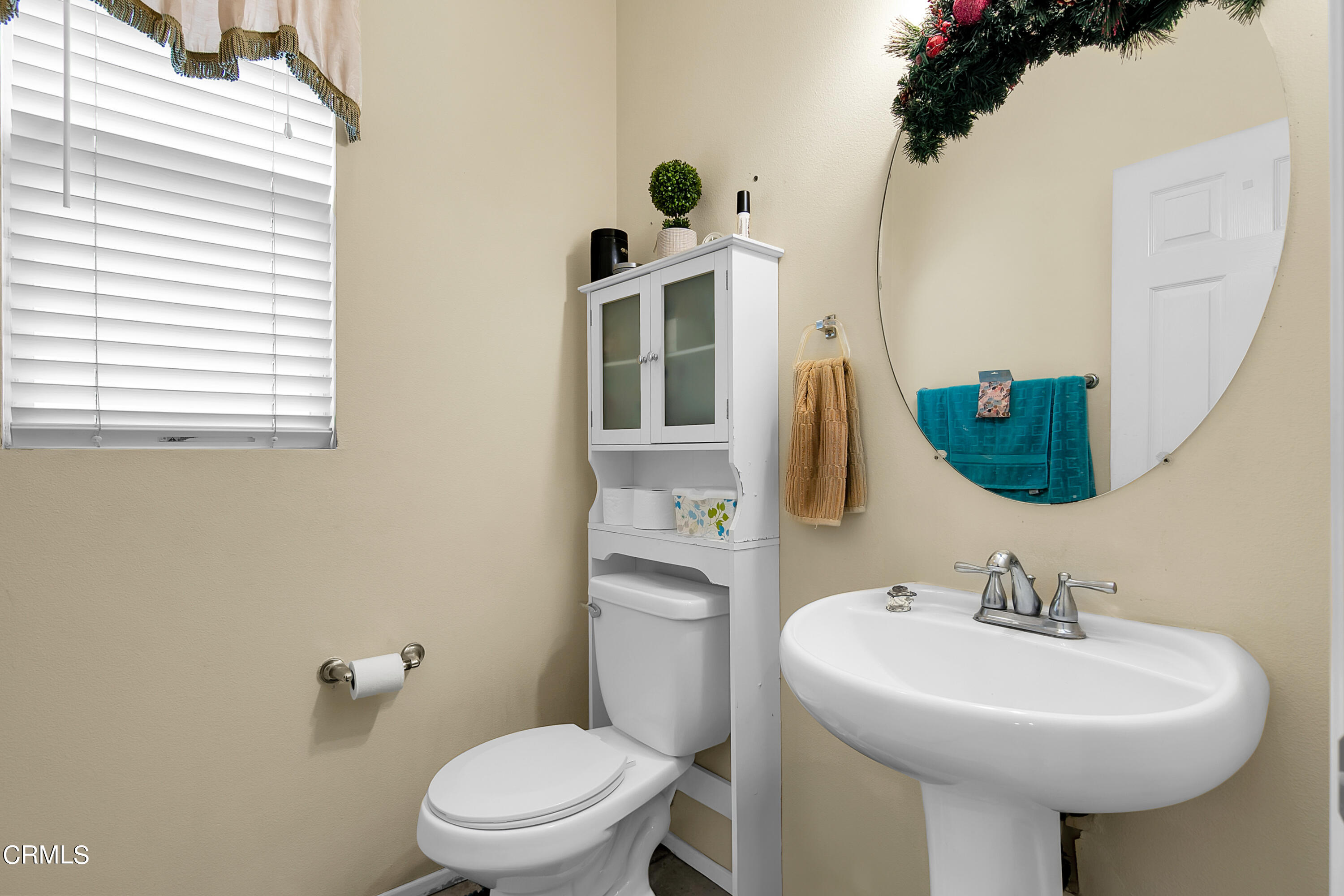 1611 Sonata Drive Oxnard, CA 93030 - Photo 17 of 25 a bathroom with a sink a mirror and a toilet