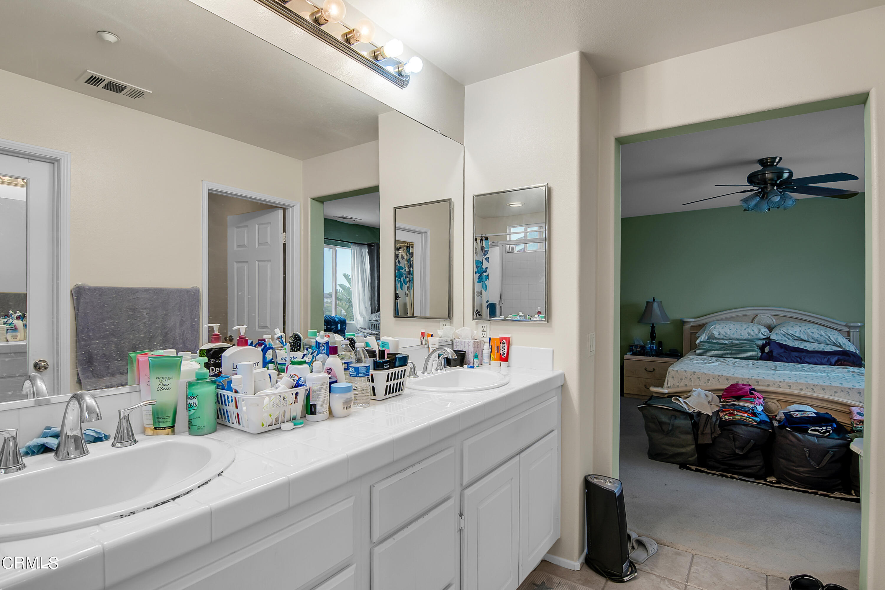 1611 Sonata Drive Oxnard, CA 93030 - Photo 18 of 25 a bathroom with a double vanity sink and a mirror
