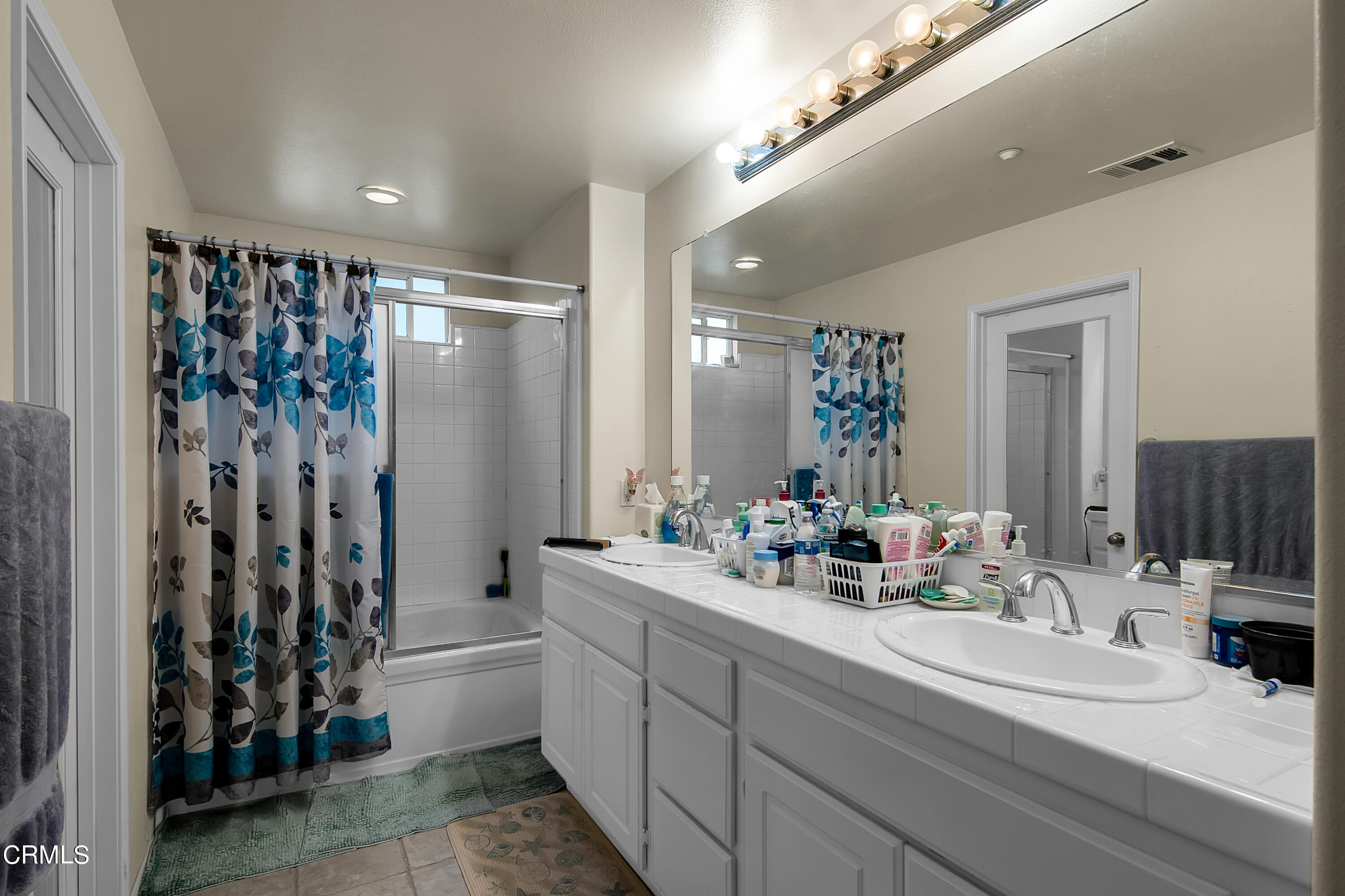 1611 Sonata Drive Oxnard, CA 93030 - Photo 20 of 25 a bathroom with double vanity and a mirror