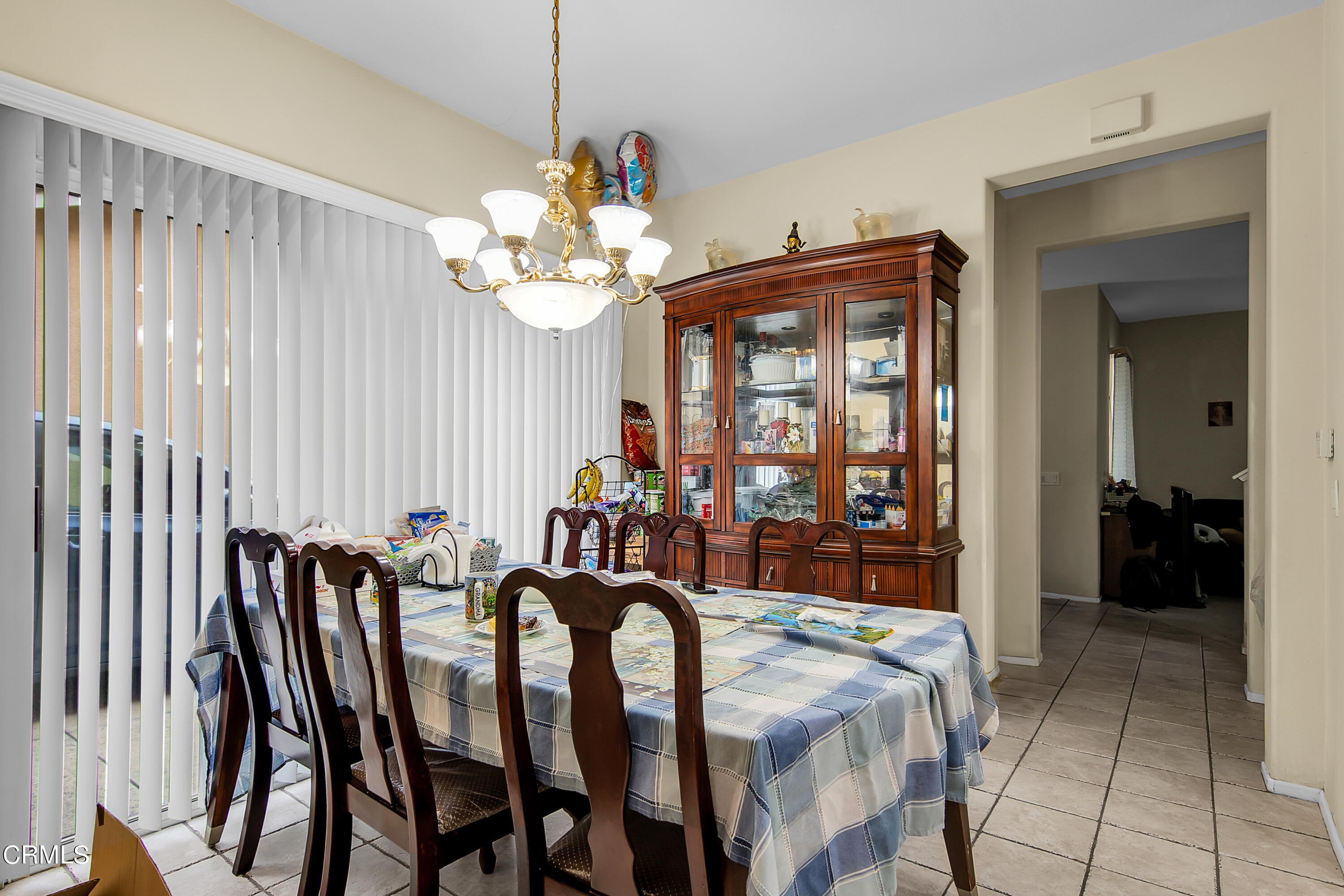 1611 Sonata Drive Oxnard, CA 93030 - Photo 4 of 25 a view of a dining room with furniture and chandelier