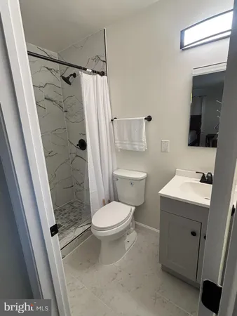 a bathroom with a shower toilet and sink