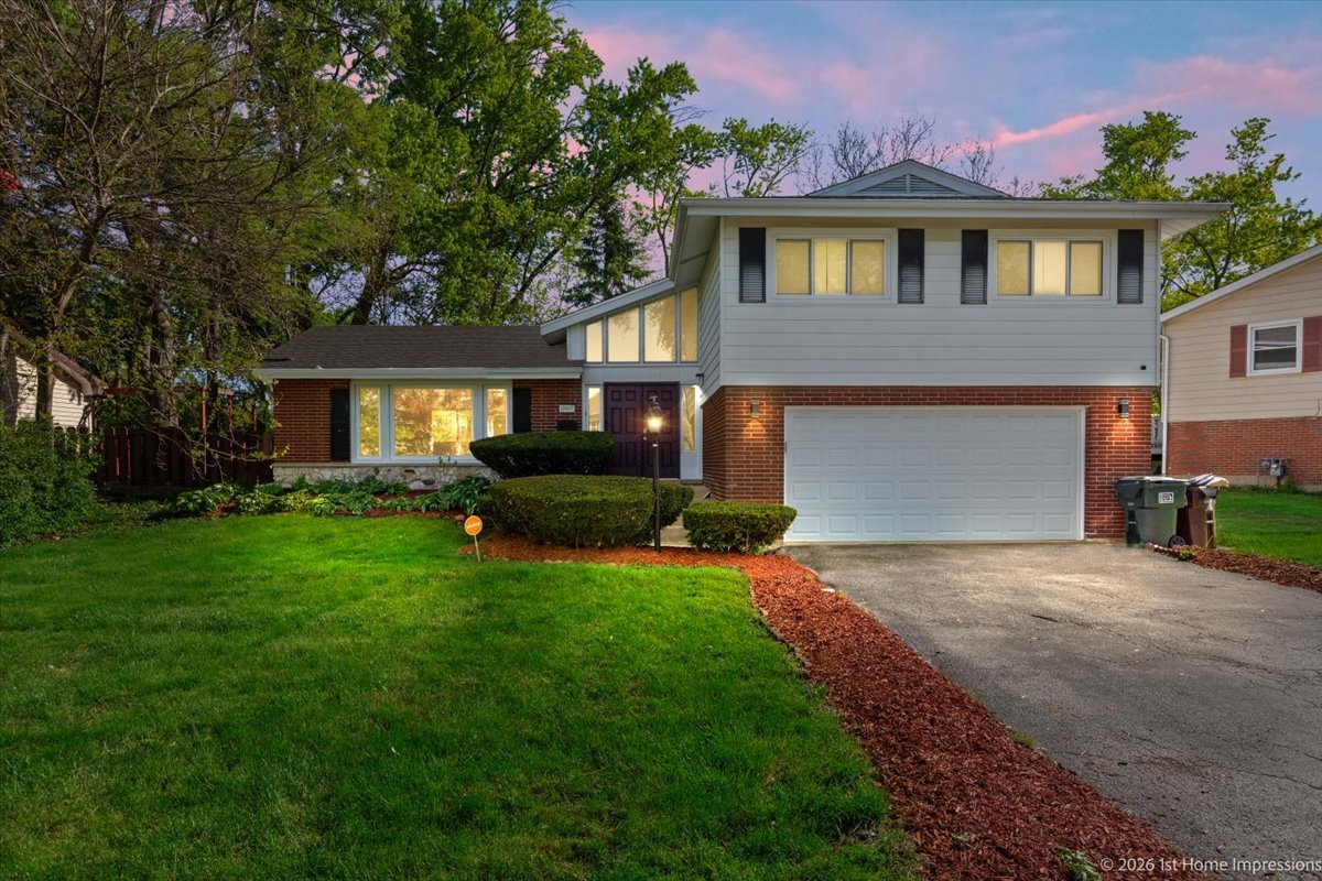 18847 May Avenue Homewood, IL 60430 - Photo 2 of 26 a front view of a house with a garden and yard