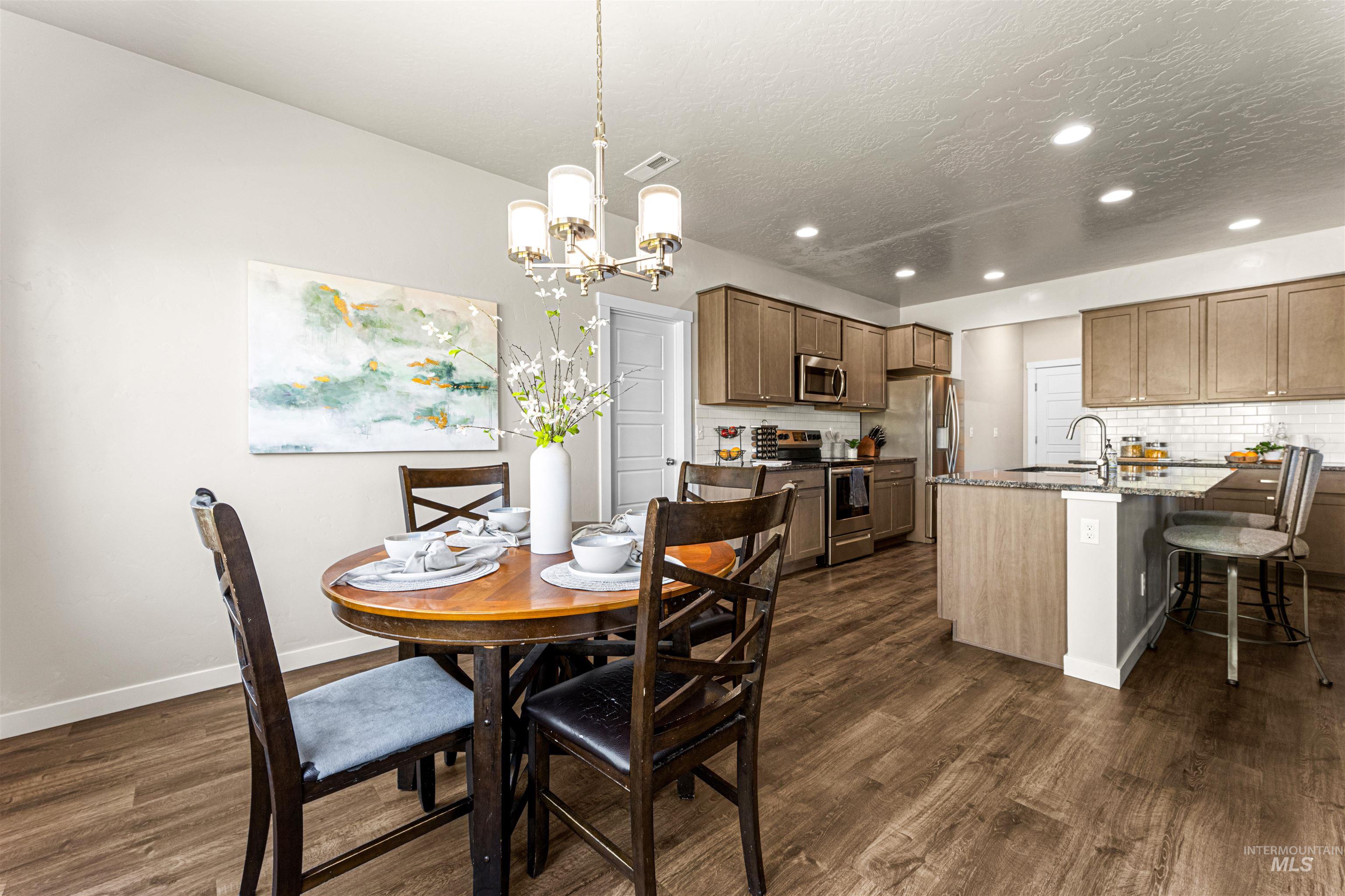 10890 West Sharpthorn Street Boise, ID 83709 - Photo 17 of 50 Open-concept living space featuring wood-finish flooring throughout