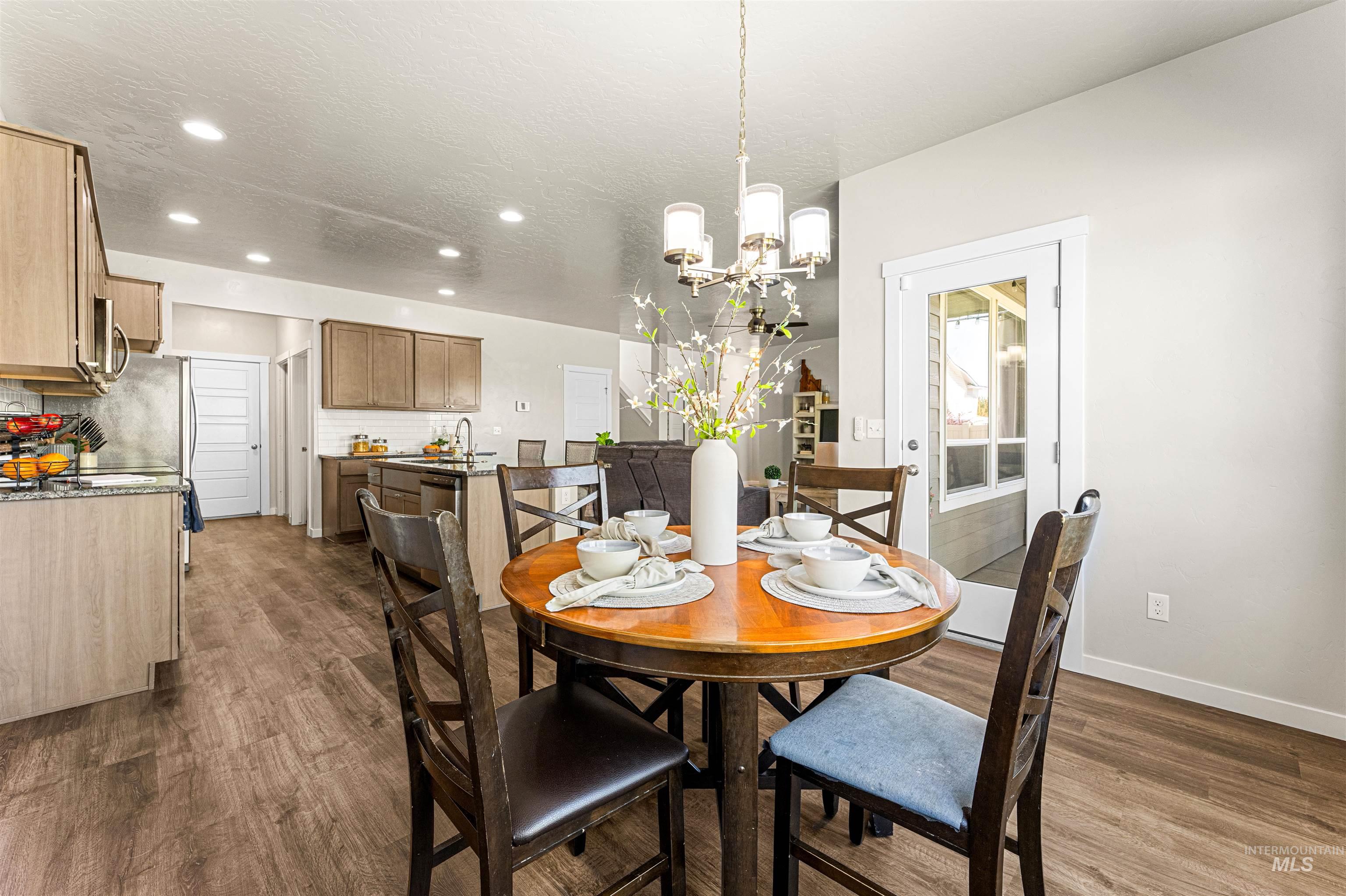 10890 West Sharpthorn Street Boise, ID 83709 - Photo 20 of 50 Open-concept dining area featuring wood-finish flooring
