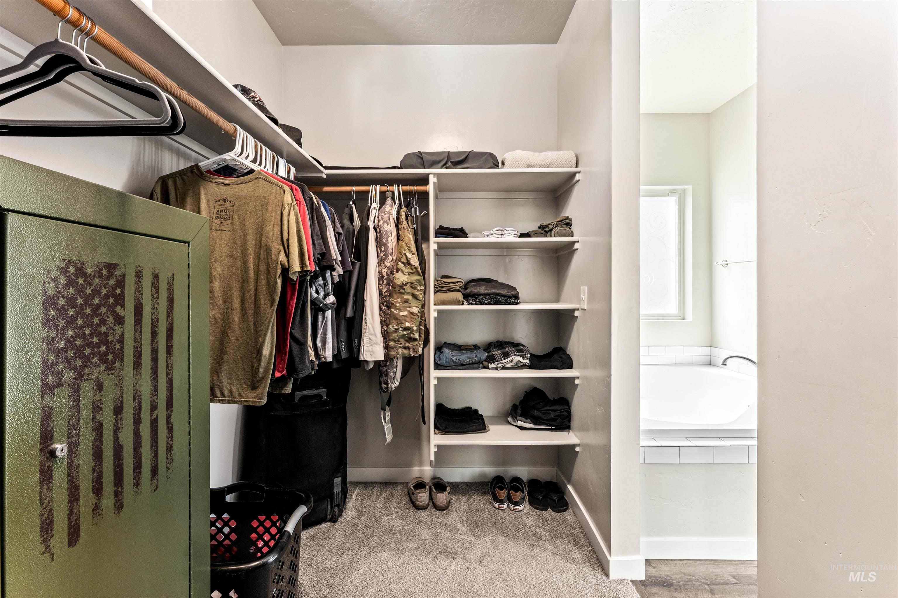 10890 West Sharpthorn Street Boise, ID 83709 - Photo 28 of 50 Walk-in closet featuring carpet flooring, built-in shelving, and clothes hanging rods