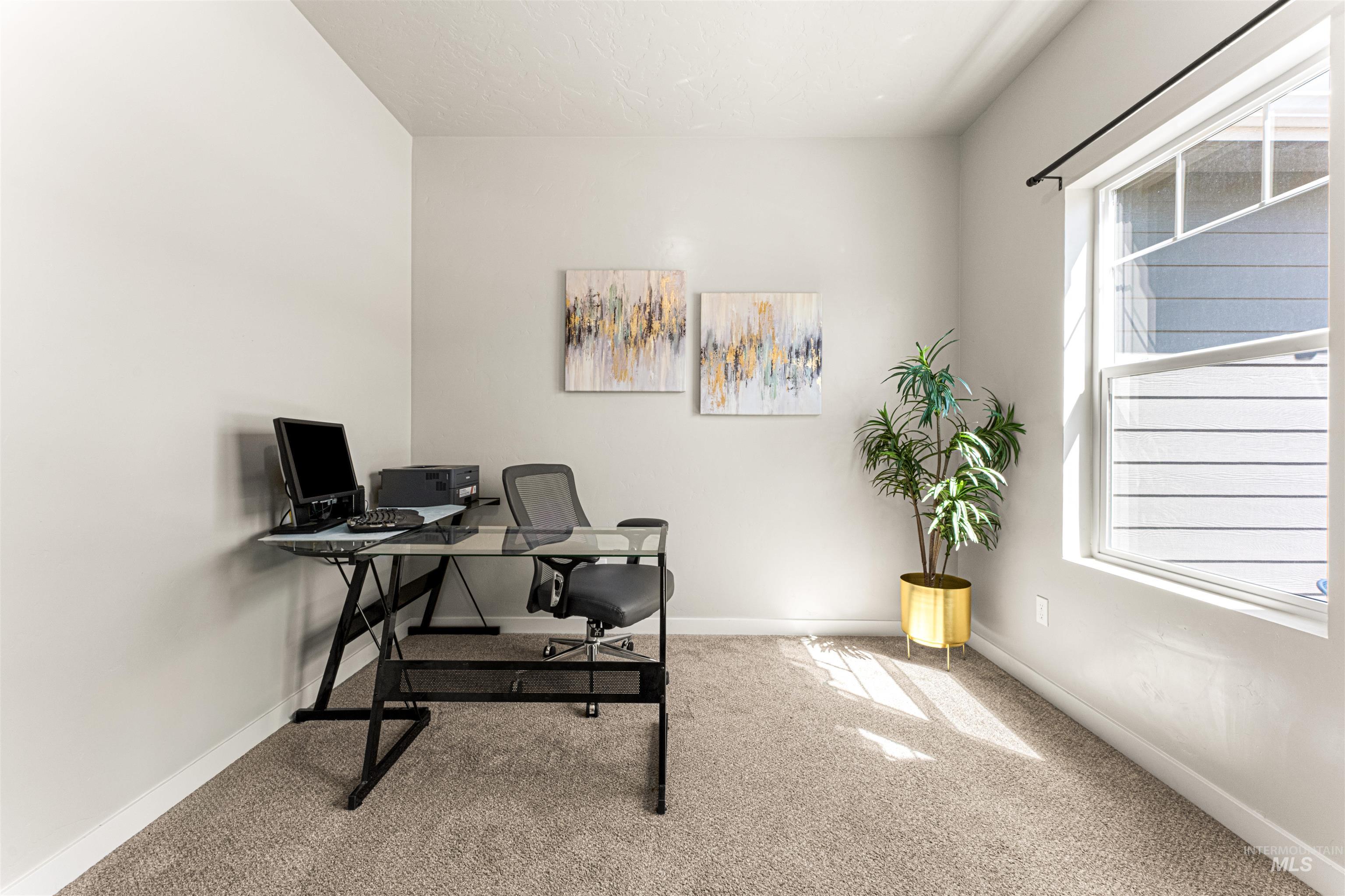 10890 West Sharpthorn Street Boise, ID 83709 - Photo 29 of 50 Spacious room featuring neutral carpeting, light-toned walls, and a large window with white trim