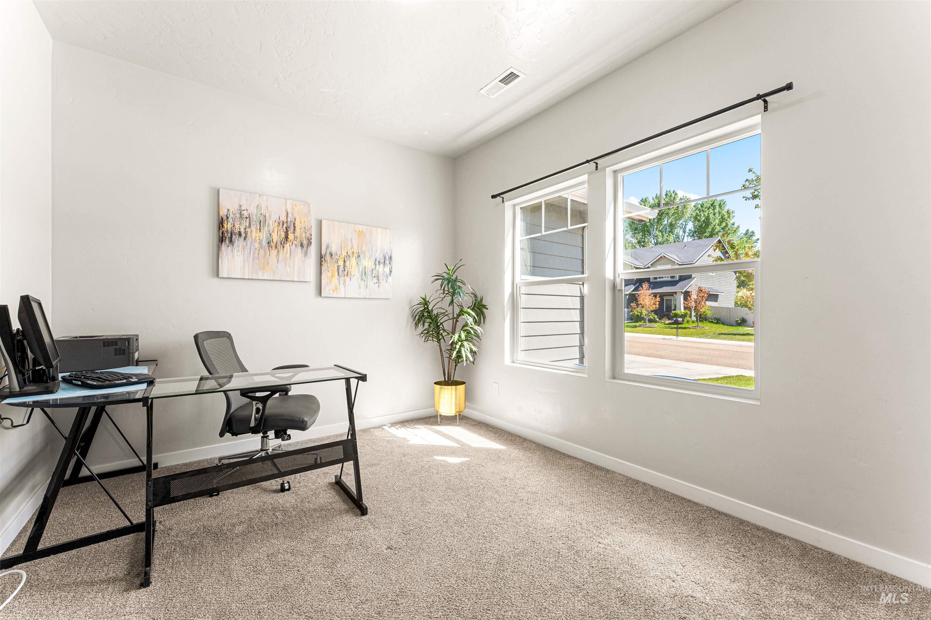 10890 West Sharpthorn Street Boise, ID 83709 - Photo 30 of 50 Bright room featuring two large windows, neutral wall tones, and light-colored carpet flooring