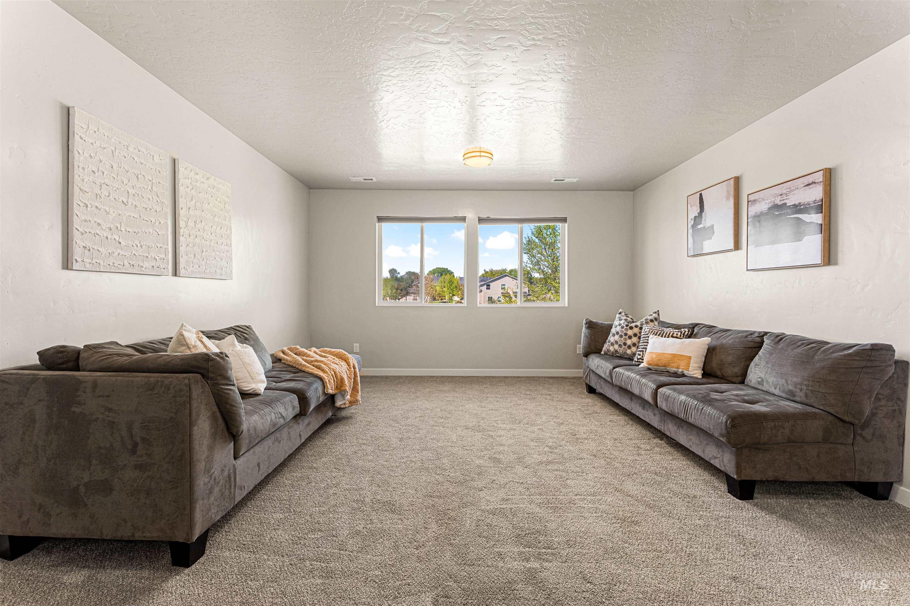 10890 West Sharpthorn Street Boise, ID 83709 - Photo 33 of 50 Bright room featuring light-toned walls and carpet flooring