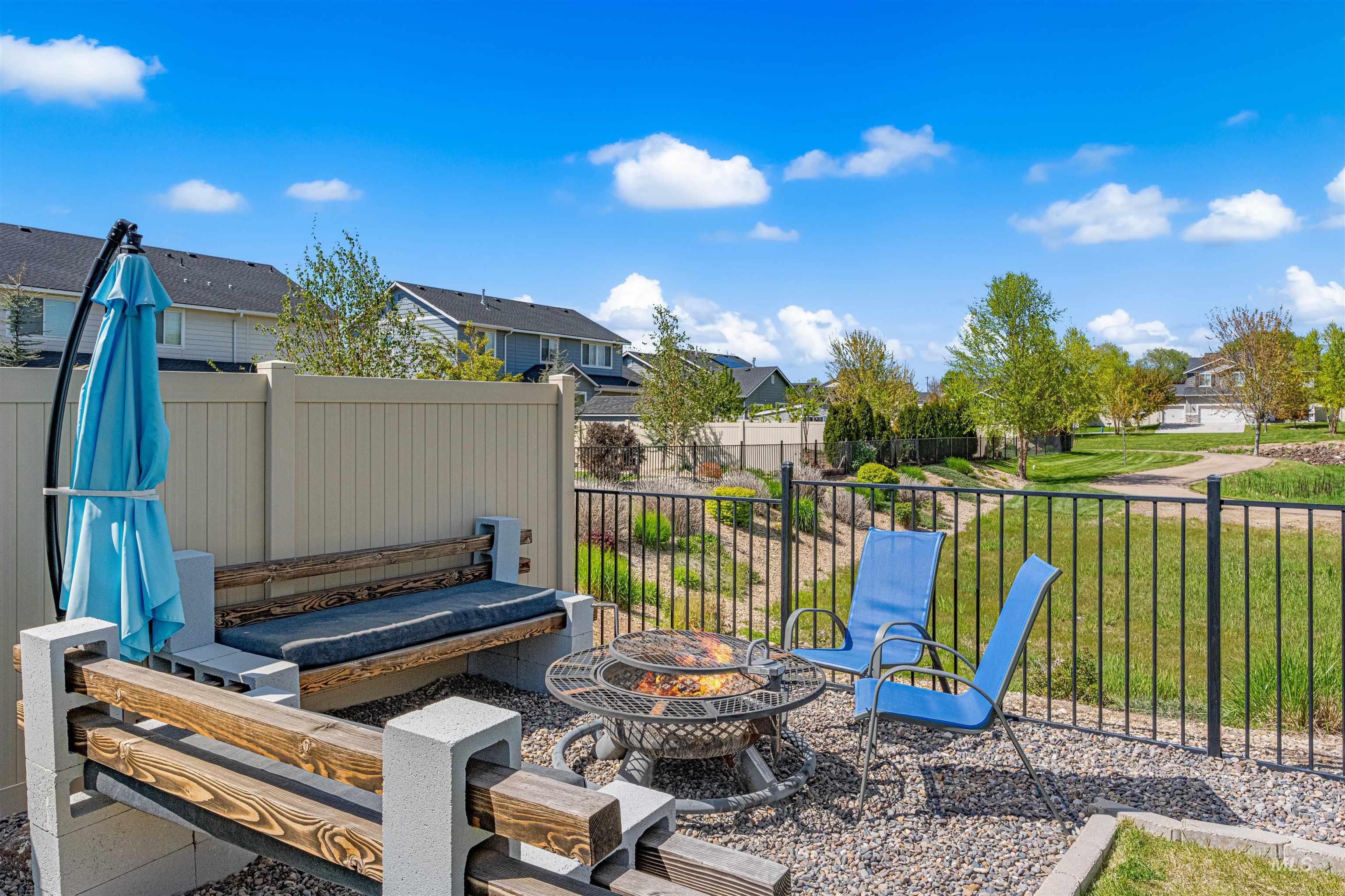 10890 West Sharpthorn Street Boise, ID 83709 - Photo 46 of 50 Outdoor patio featuring a gravel surface, a built-in bench with wood and block construction, and an open fire pit