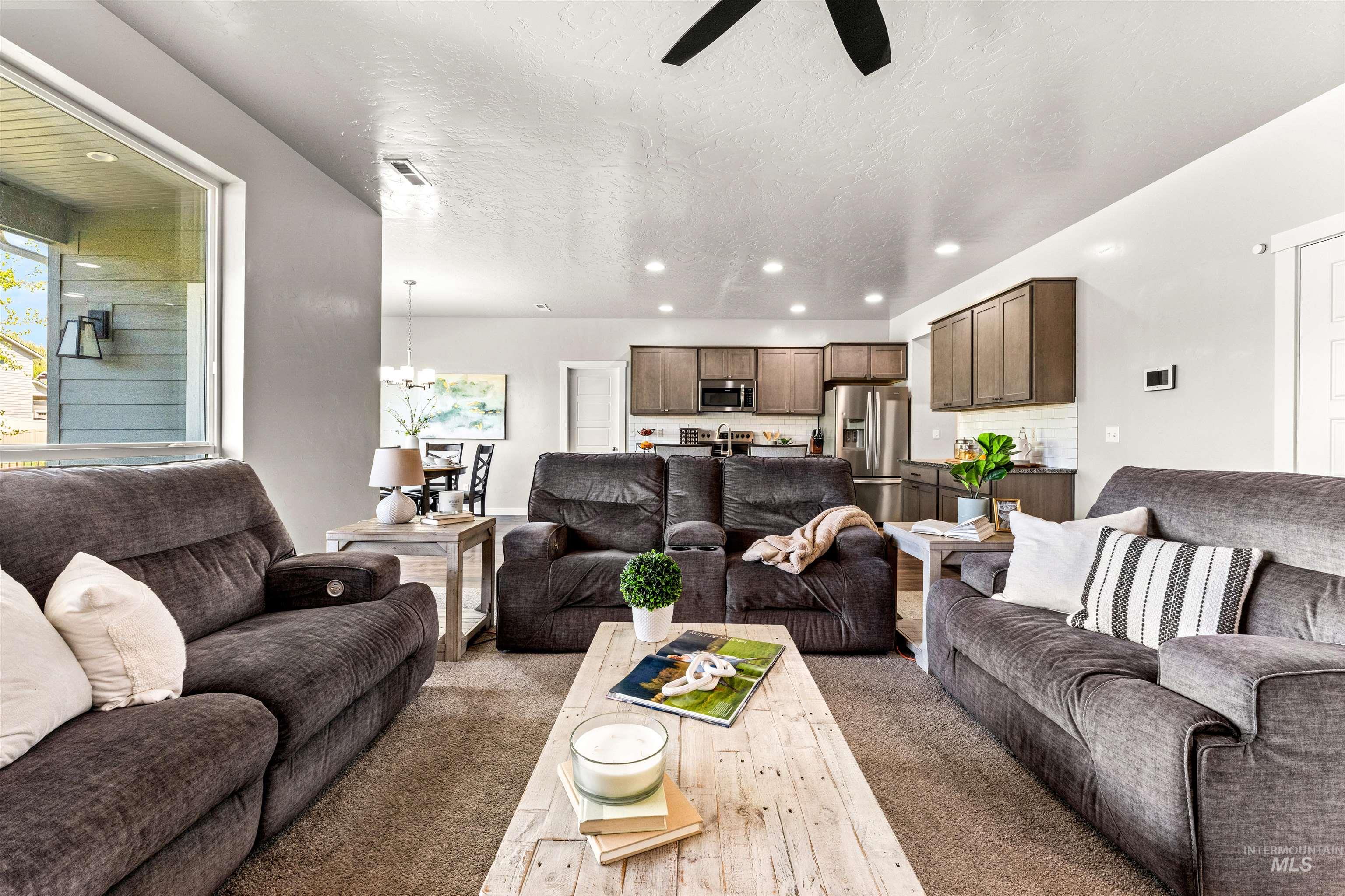 10890 West Sharpthorn Street Boise, ID 83709 - Photo 8 of 50 Open-concept living space with a ceiling fan, recessed lighting, and carpet flooring