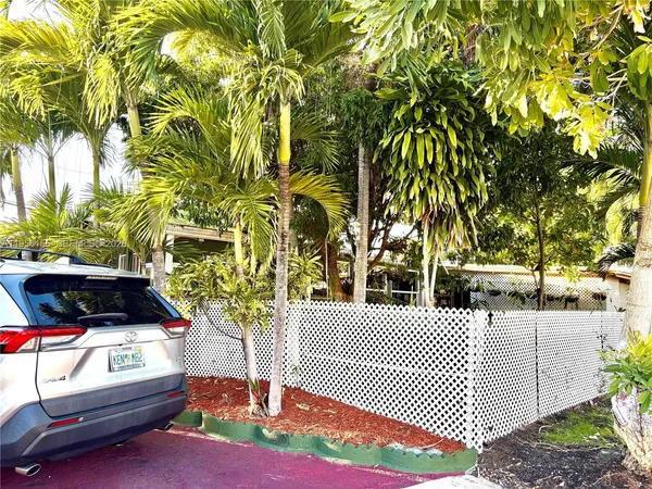 a view of a patio with table and chairs and potted plants