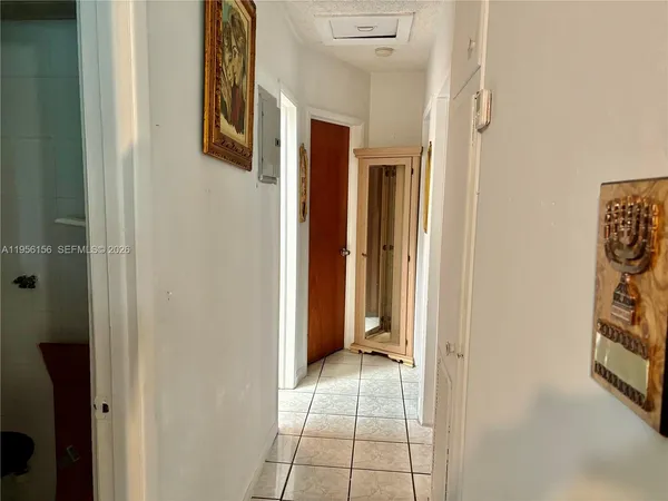 a view of a hallway with paintings on the wall