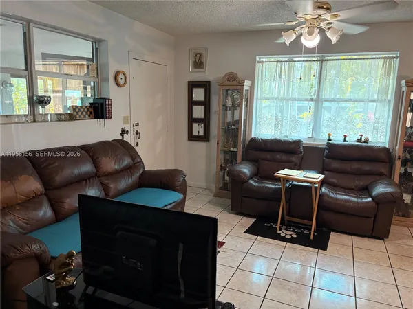 a living room with furniture and a large window