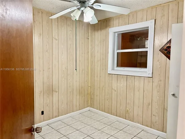 a hallway with dining area and chandelier