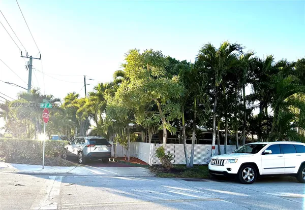 a view of a car parked on the side of a street
