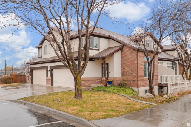 1625 Pages Pl Drive Bountiful, UT 84010 - Photo 2 of 31 Traditional-style townhouse featuring brick siding, driveway, an attached garage, stucco siding, and roof with shingles