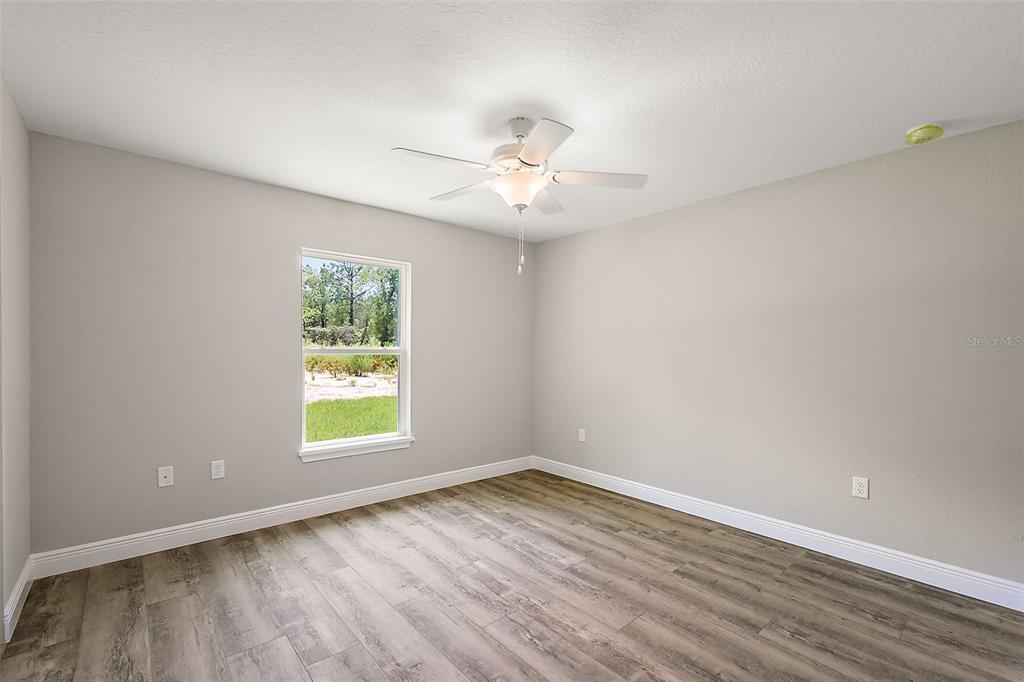 13740 Southwest 89th Street Dunnellon, FL 34432 - Photo 19 of 25 wooden floor in an empty room with a window