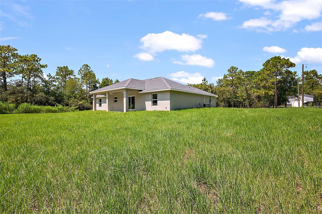 13740 Southwest 89th Street Dunnellon, FL 34432 - Photo 24 of 25 a view of a house with a big yard