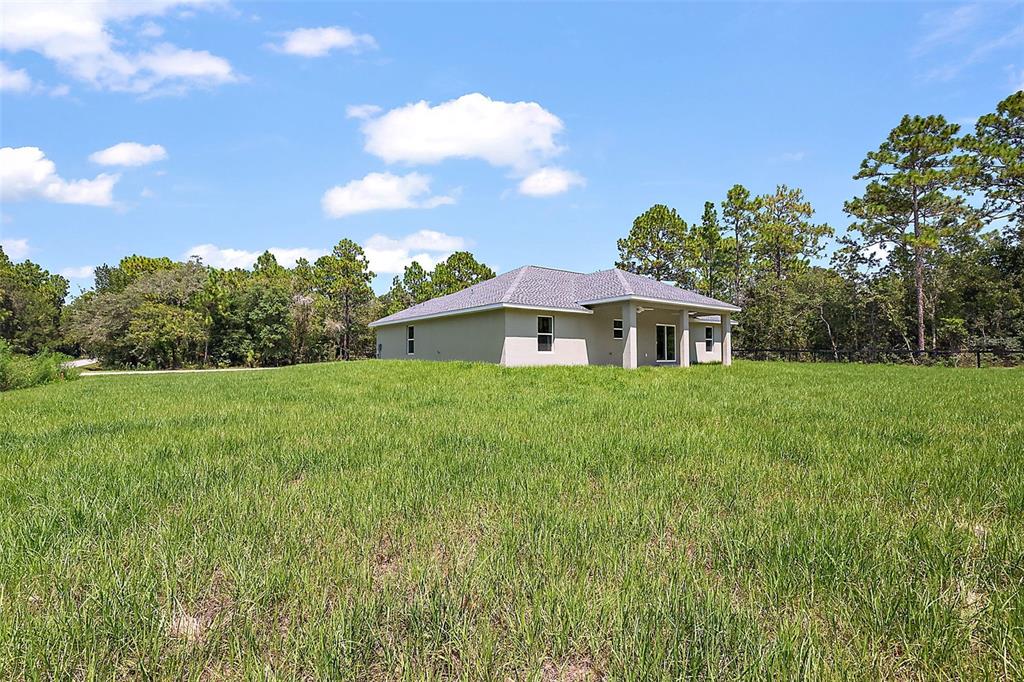 13740 Southwest 89th Street Dunnellon, FL 34432 - Photo 25 of 25 a front view of a house with garden
