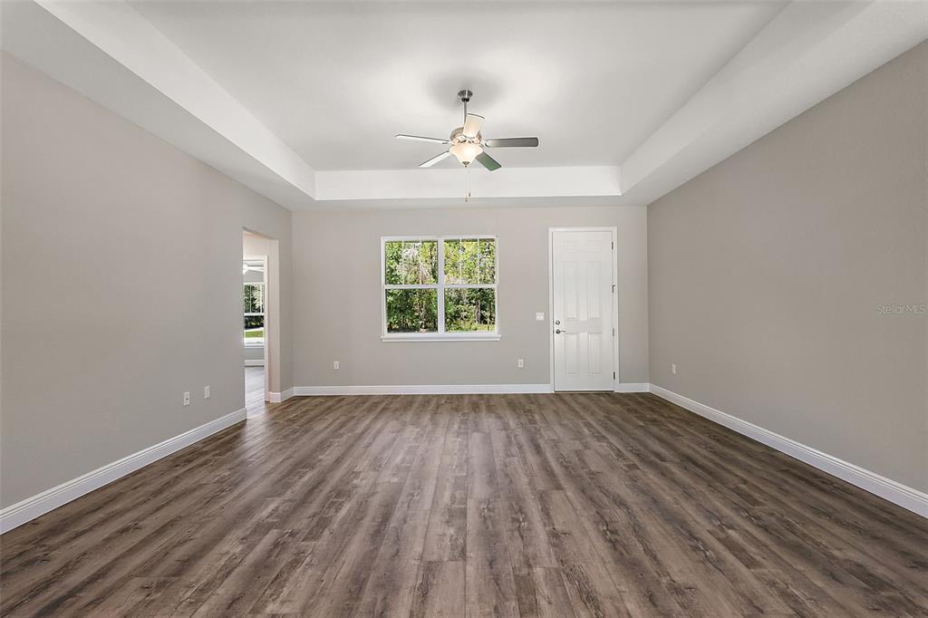 13740 Southwest 89th Street Dunnellon, FL 34432 - Photo 5 of 25 wooden floor in an empty room with a window