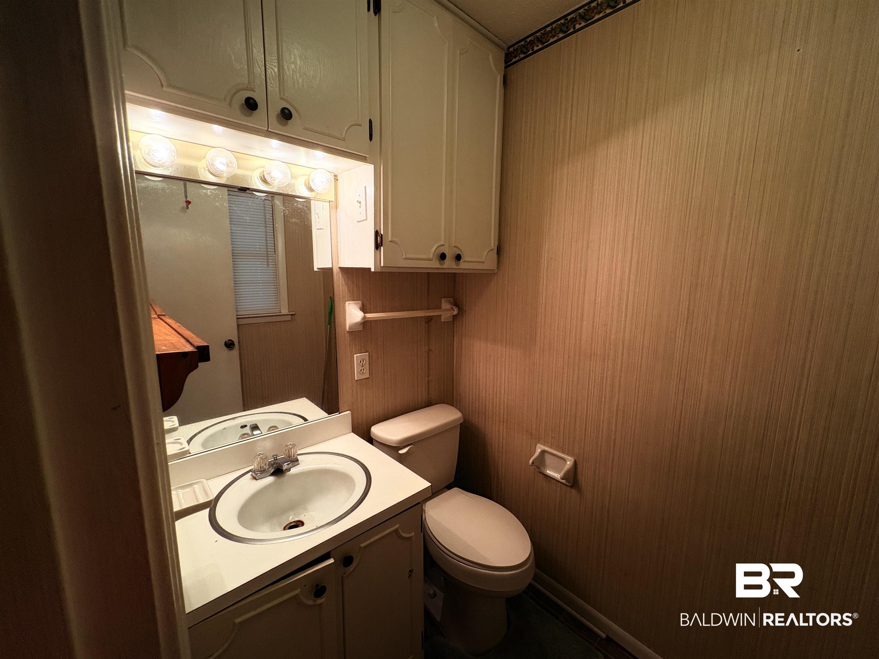 8065 Middle Ring Road Mobile, AL 36619 - Photo 11 of 21 Half bathroom with vanity and toilet