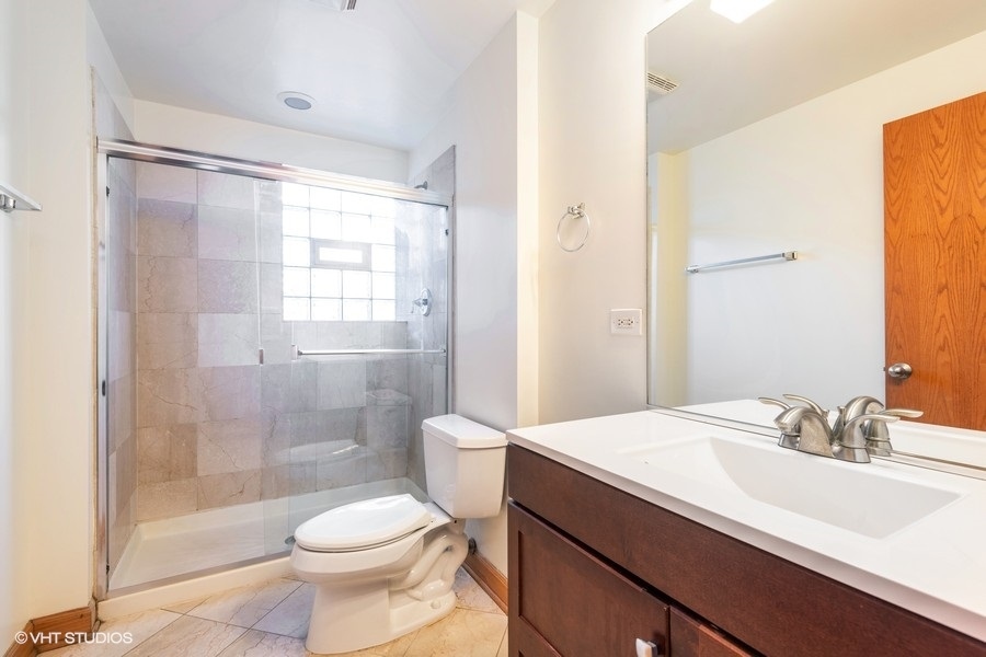 Undisclosed Address Chicago, IL 60657 - Photo 12 of 13 a bathroom with a sink toilet and shower