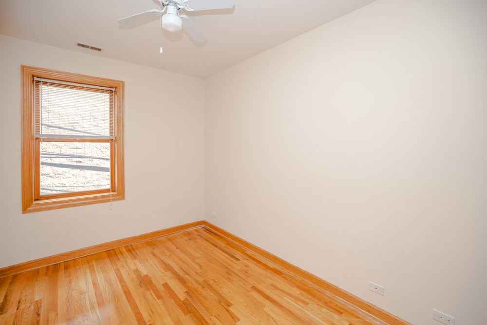 Undisclosed Address Chicago, IL 60657 - Photo 2 of 13 an empty room with a window and chandelier fan