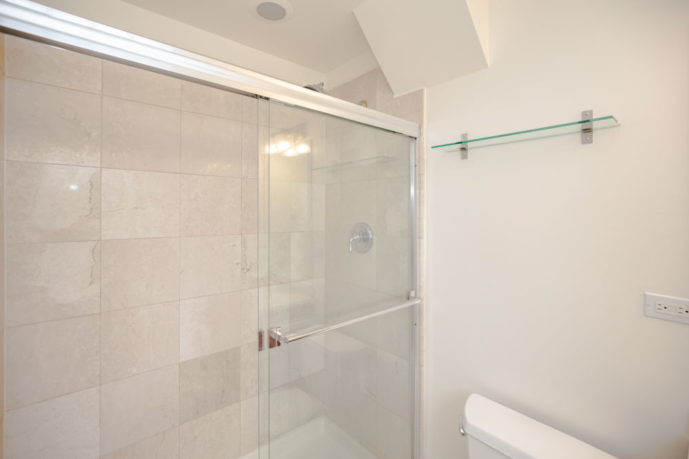 Undisclosed Address Chicago, IL 60657 - Photo 6 of 13 a bathroom with a shower and a toilet