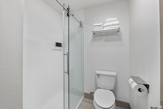 245 Red Cliffs Drive, Unit 104 St. George, UT 84790 - Photo 22 of 33 Bathroom featuring a stall shower and toilet