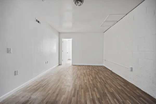 a view of an empty room and wooden floor