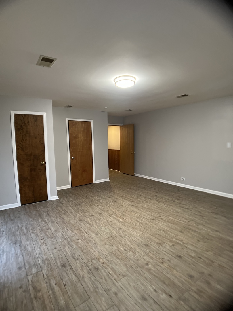 16237 Trumbull Avenue Markham, IL 60428 - Photo 13 of 18 an empty room with closet and mirror