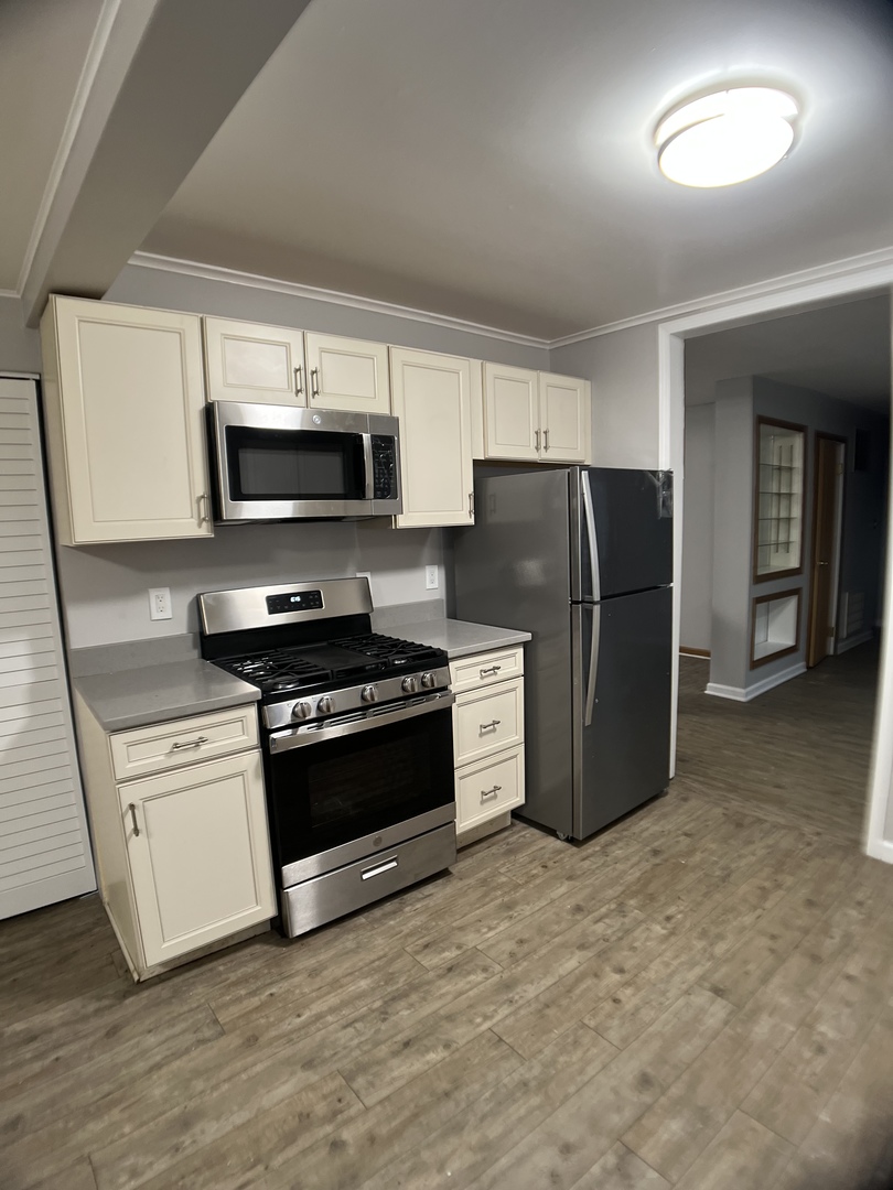 16237 Trumbull Avenue Markham, IL 60428 - Photo 6 of 18 a kitchen with stainless steel appliances a refrigerator stove and microwave