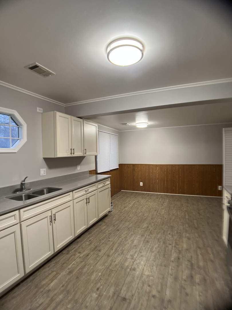16237 Trumbull Avenue Markham, IL 60428 - Photo 8 of 18 a large white kitchen with a sink and cabinets