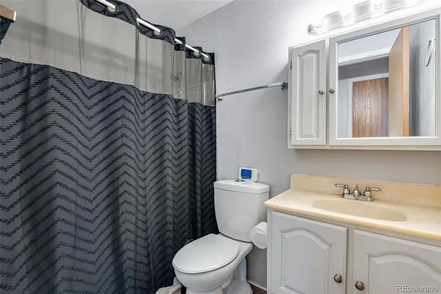 a white toilet sitting next to a bathroom sink