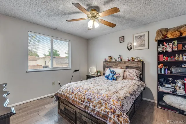 a bedroom with a bed a dresser and a book shelf