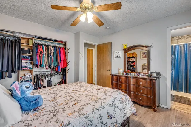 a bedroom with a bed and a dresser in it