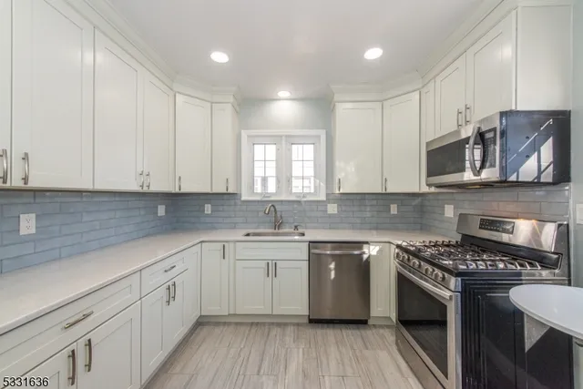 a kitchen with a sink stove and cabinets