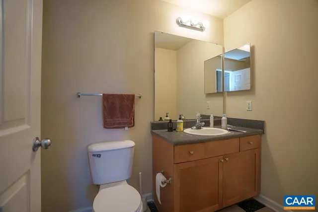a bathroom with a toilet sink and mirror