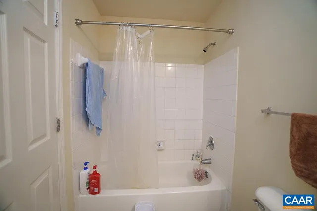 a bathroom with a shower curtain and a bathtub