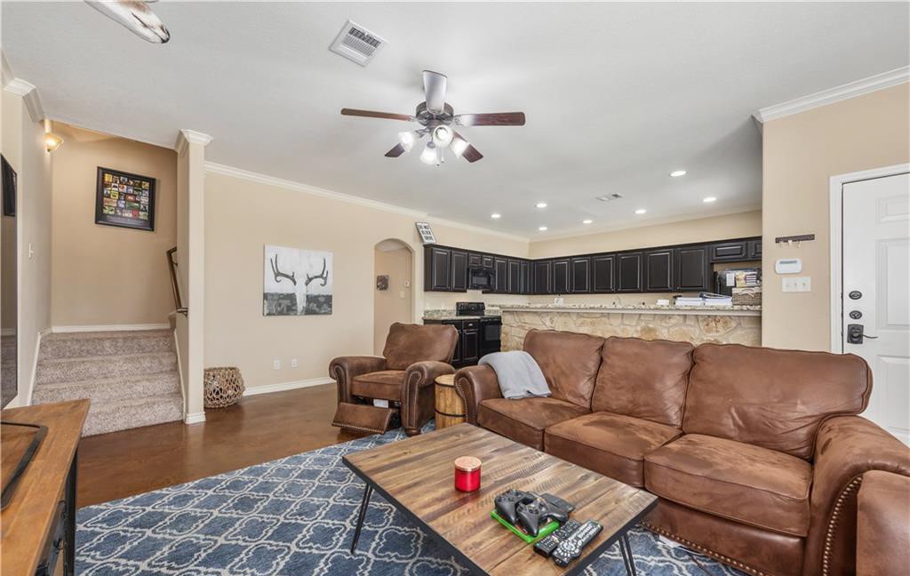 3201 Cain Road College Station, TX 77845 - Photo 2 of 8 Living area with crown molding, arched walkways, ceiling fan, and recessed lighting